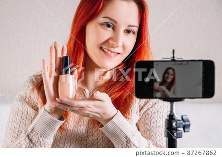 Beauty blogger influencer leads online stream. Young woman shows how to do makeup and use cosmetics. Beauty blogger influencer leads online stream. Young woman shows how to do makeup and use cosmetics. 87267862
