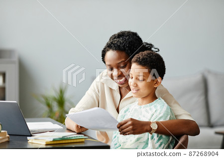 Happy Mother Helping Daughter with Homework 87268904