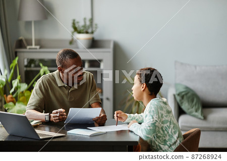 Girl Studying at Home with Father 87268924