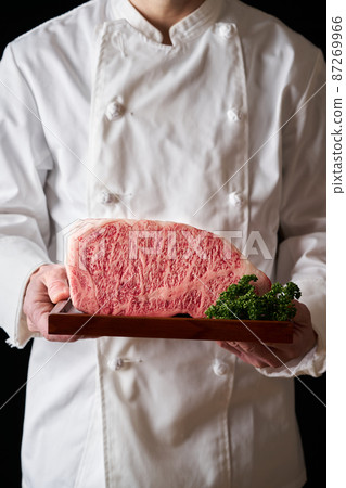 A cook holding a Japanese black beef loin steak in his hand A cook holding a Japanese black beef loin steak in his hand 87269966
