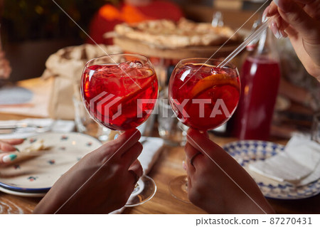Italian cocktail with orange slices on gray stone table. Summer drink, homemade. 87270431