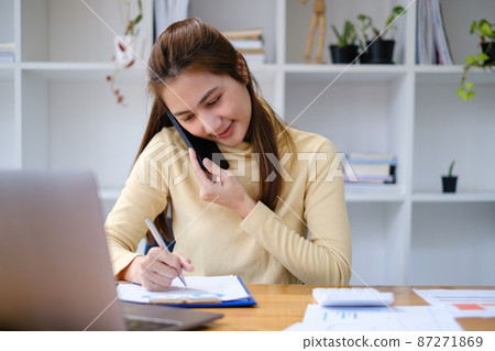 Portrait of Busy Asian Secretary waiting customer while working at office. Business Finance concept. 87271869