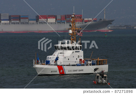 US Coast Guard patrol boat "Hawksbill" and a large container ship 87271898
