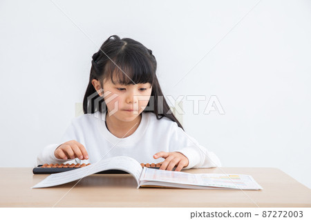 Girl learning abacus homework 87272003