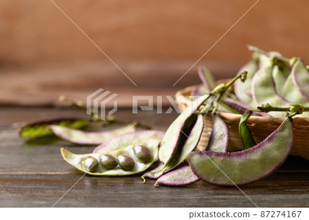 Asian Hyacinth bean in basket on wooden background Asian Hyacinth bean in basket on wooden background 87274167