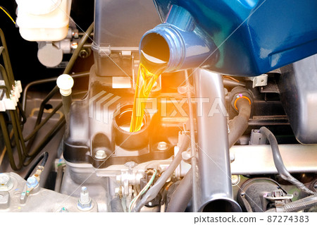 Refueling and pouring oil quality into the engine motor car Transmission and Maintenance Gear .Energy fuel concept. Refueling and pouring oil quality into the engine motor car Transmission and Maintenance Gear .Energy fuel concept. 87274383