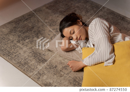 A woman relaxing at home at night A woman relaxing at home at night 87274550