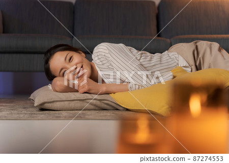 A woman relaxing at home at night 87274553