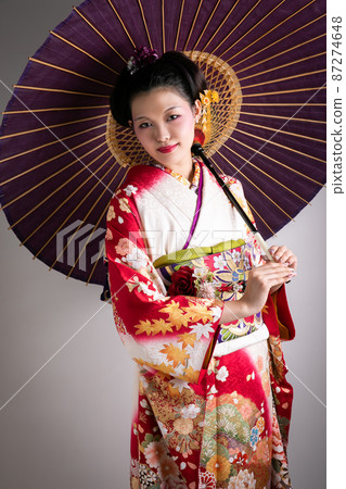 A woman wearing furisode and holding an umbrella Japan A woman wearing furisode and holding an umbrella Japan 87274648