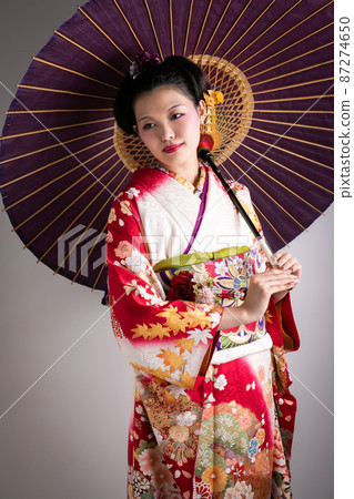 A woman wearing furisode and holding an umbrella Japan 87274650