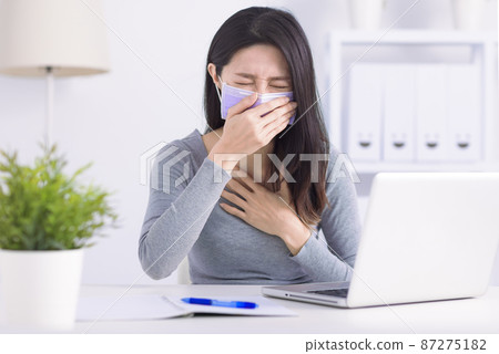 Stressed young woman wearing medical face mask Stressed young woman wearing medical face mask 87275182