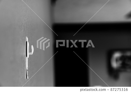 Selective focus on adhesive strip wall hanger that can be removed by pulling tape Selective focus on adhesive strip wall hanger that can be removed by pulling tape 87275316