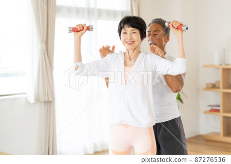 Senior couple doing muscle training Senior couple doing muscle training 87276536