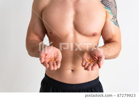 Fish oil is eaten by a man in the hands of vials and a glass bottle pill health supplement, diet drug liver omega, medication People smile taking, health female giving dieting 87279923