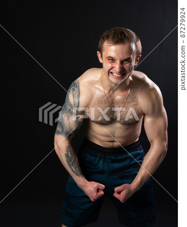 Man on black background keeps dumbbells pumped up in fitness biceps athlete weight workout athletic dumbbell, male weightlifting. Lift handsome metal, gym fit 87279924