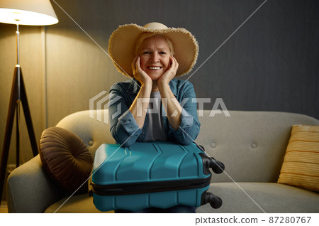 Smiling aged woman tourist looking at camera Smiling aged woman tourist looking at camera 87280767