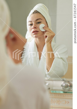 Woman Applying Face Toner Woman Applying Face Toner 87281547