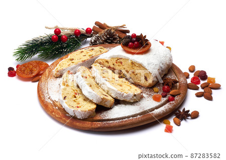 Sliced Traditional Christmas stollen cake with marzipan and dried fruit isolated on white background Sliced Traditional Christmas stollen cake with marzipan and dried fruit isolated on white background 87283582