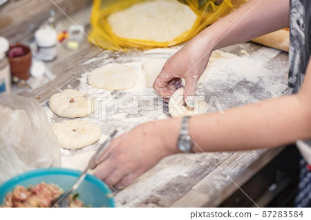 Preparation of a traditional Caucasian dish with meat - bilyash Preparation of a traditional Caucasian dish with meat - bilyash 87283584