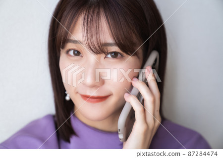 Woman making phone call with smartphone 87284474