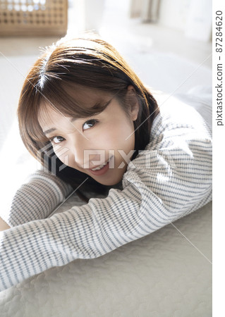 Woman lying down in the room Woman lying down in the room 87284620