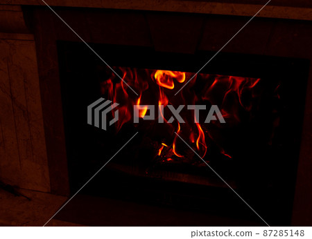Red flames in a home fireplace 87285148