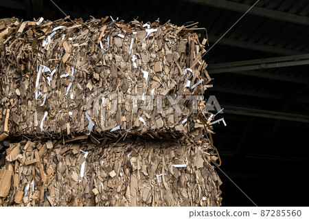A pile of small pieces of paper for recycling in the shape of a box indoors A pile of small pieces of paper for recycling in the shape of a box indoors 87285560