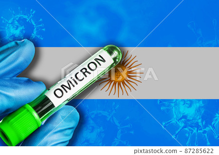 Argentina outbreak of omicron variant. Hand holds a test tube with covid-19 virus omicron in front of Argentina flag 87285622