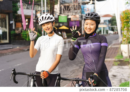 two beautiful asian road bike cyclist showing thumb up two beautiful asian road bike cyclist showing thumb up 87285708