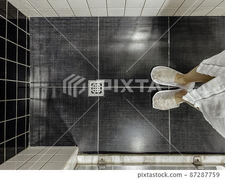 Floor drain, running water in shower, White and black tiles 87287759