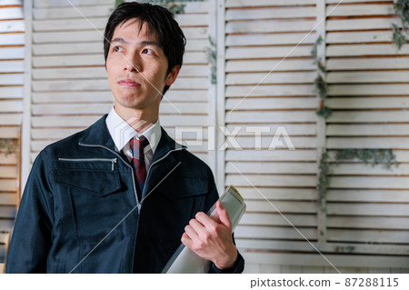 A man in work clothes with documents A man in work clothes with documents 87288115