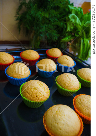 Cool freshly baked vanilla muffins on a metal sheet. Cool freshly baked vanilla muffins on a metal sheet. 87289173