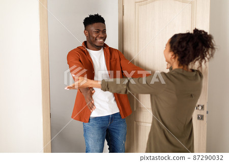 Cheerful Black Couple Stretching Hands For An Embrace At Home Cheerful Black Couple Stretching Hands For An Embrace At Home 87290032
