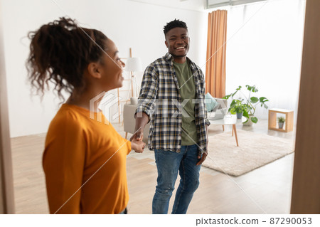 Black Couple Entering Their House Holding Hands Standing Indoors 87290053