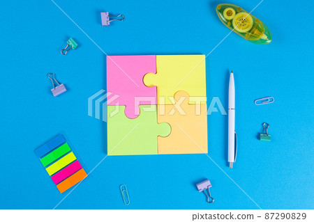 Blank sticky notes in the form of a puzzle on a blue background, space for text Blank sticky notes in the form of a puzzle on a blue background, space for text 87290829