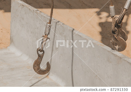 Heavy iron hook lifting mechanism with a steel cable rope with a concrete, cement structure on construction site industry Heavy iron hook lifting mechanism with a steel cable rope with a concrete, cement structure on construction site industry 87291330