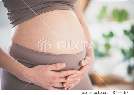 Pregnant woman belly. Pregnancy Concept. Pregnant tummy close up. Detail of pregnant woman relaxed at home. 87291621