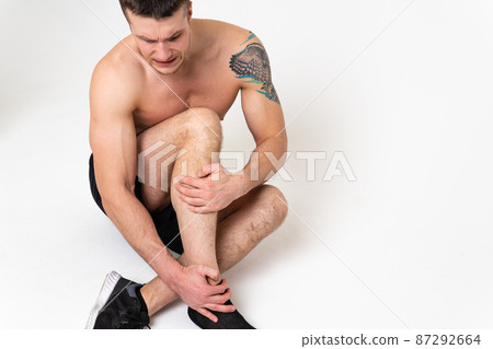 A man's kneecap hurts on a white background sore painful, backache spine male massage medical, muscular chronic. therapy, lower suffer attractive 87292664