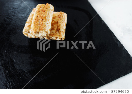 Pancakes envelopes stuffed with chicken Pancakes envelopes stuffed with chicken 87294650