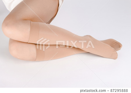 Medical Compression Stockings for varicose veins and venouse therapy. Compression Hosiery. Sock for sports isolated on white background. Black color socks mock up for advertising, branding, design. 87295888