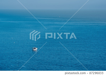 seascape with a lonely fishing boat, view from above seascape with a lonely fishing boat, view from above 87296833