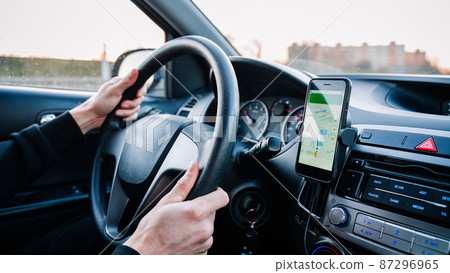 Gps navigation map system. Global positioning system on smartphone screen in auto car on travel road. GPS device satellite system technology. Gps navigation map system. Global positioning system on smartphone screen in auto car on travel road. GPS device satellite system technology. 87296965
