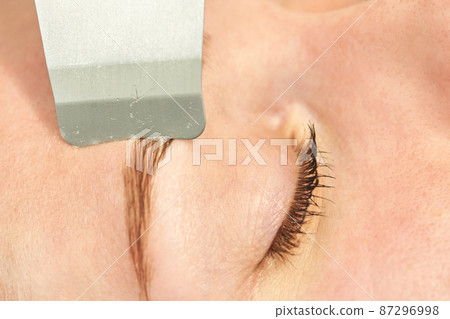 Ultrasound cosmetology scrubber. Face cavitation procedure. Salon skincare 87296998