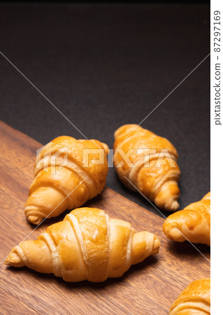 Fresh croissants on a wooden board. selective focus .bakery with copy space. 87297169