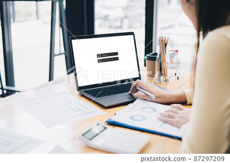 A business woman using laptop computer to cyber security for her saving account, business, technology, future, digital asset Concept. A business woman using laptop computer to cyber security for her saving account, business, technology, future, digital asset Concept. 87297209