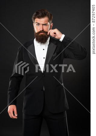 elegant butler in tuxedo on black background, menswear elegant butler in tuxedo on black background, menswear 87297405