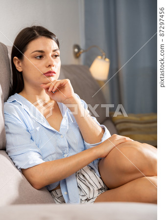 Woman is thoughtful and bored alone at home Woman is thoughtful and bored alone at home 87297456