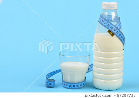 Calcium nutrition and healthy diet. Milk containers wrapped with tape Calcium nutrition and healthy diet. Milk containers wrapped with tape 87297733