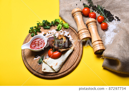 Traditional cuisine. Roasted steak with tomato, flatbread and grilled onion Traditional cuisine. Roasted steak with tomato, flatbread and grilled onion 87297734