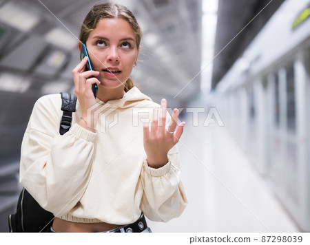 Young european female with mobile waiting the metro Young european female with mobile waiting the metro 87298039